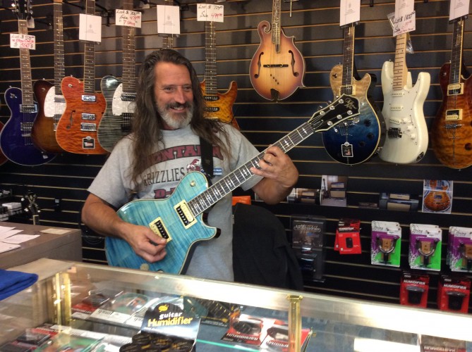 Marko at Morgenroth Music with a Michael Kelly Patriot electric guitar