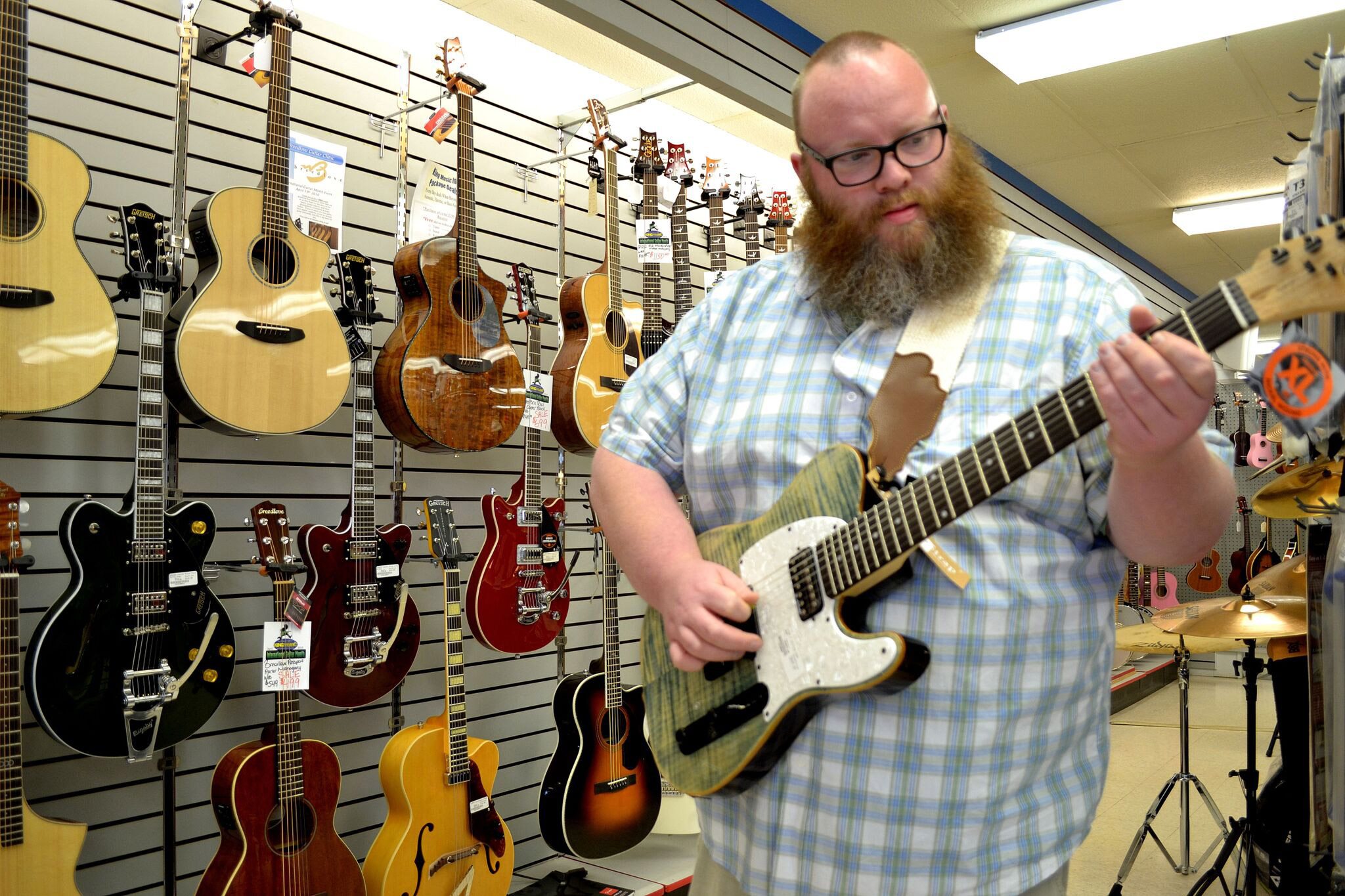 Jon from King Music Inc holding a Michael Kelly 1950s CC50 7-string electric guitar