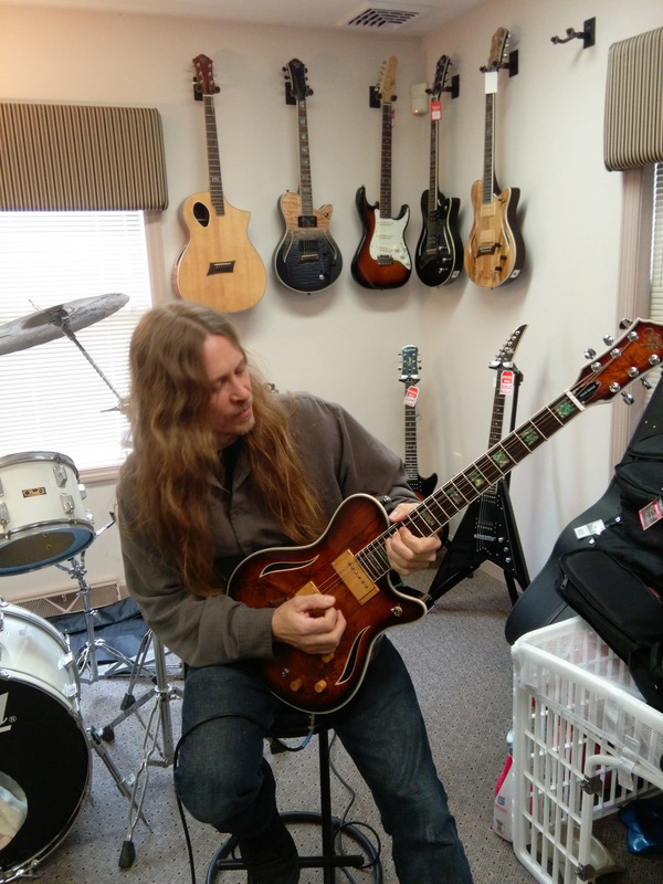 Robert Putt playing a Michael Kelly Hybrid acoustic electric guitar
