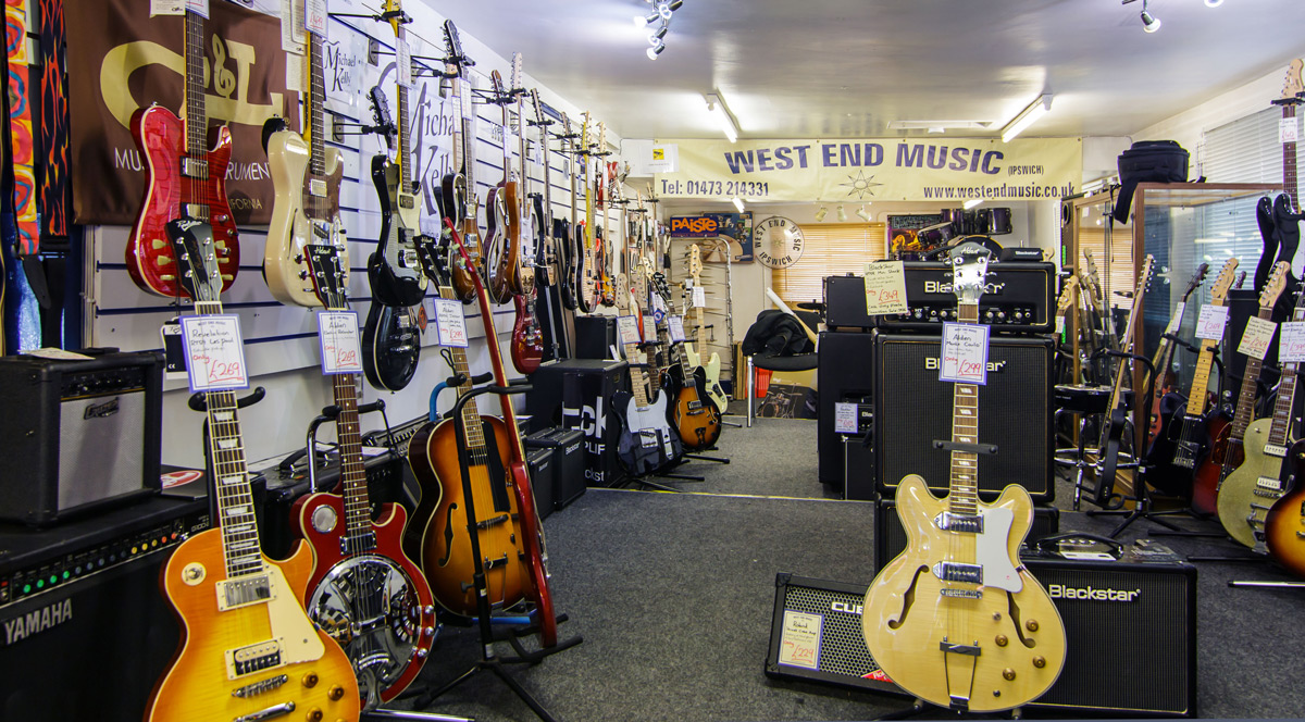 West End Music store with electric guitars, acoustic guitars, telecasters, stratocasters, amps, amplifiers, and guitar straps and guitar accessories